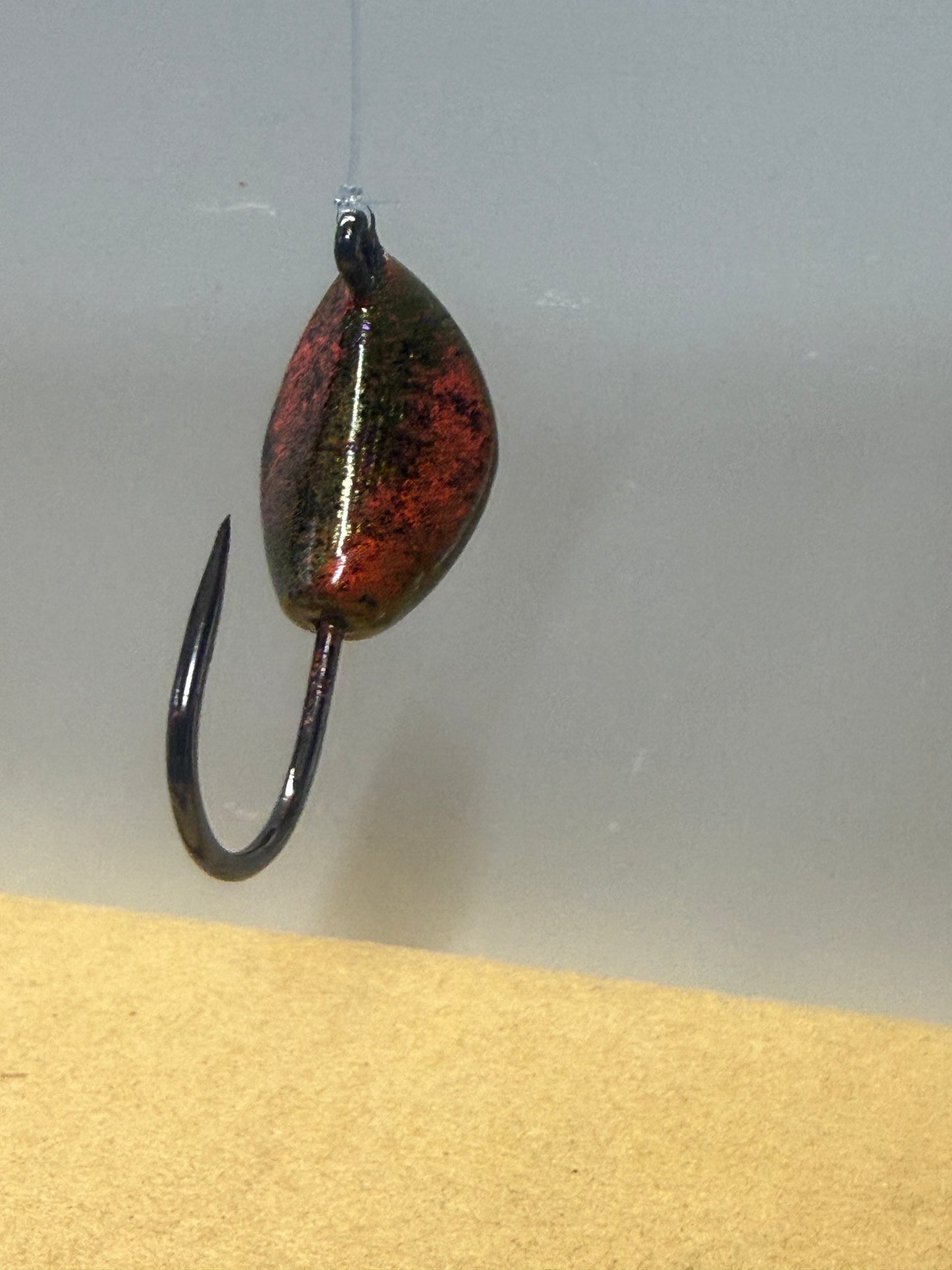 Greenish base with accents of black and orange.